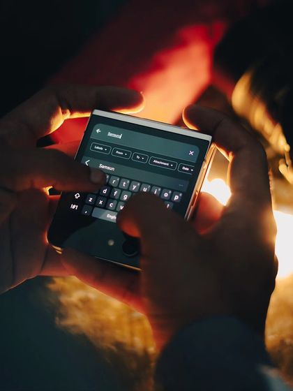 A close-up of the Samsung Galaxy Z Flip 5's cover screen in use. This shot focuses on the product's functionality, captured with dramatic lighting to make it feel both useful and desirable.