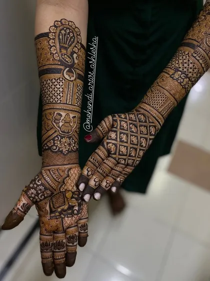 A full bridal design featuring a mix of traditional motifs. The arms are adorned with peacocks and kalash symbols, while the palms have intricate grid work.