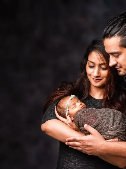 A beautiful moment between new parents as they lovingly gaze at their newborn baby. These parent and baby portraits are about capturing that pure, early connection.
