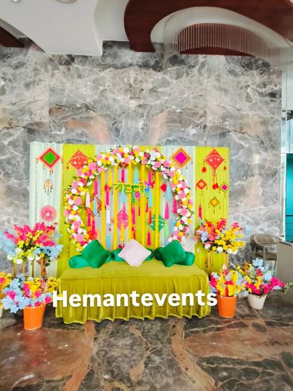 A full view of an indoor Mehendi seating area. This compact and vibrant setup is ideal for home functions or smaller gatherings.