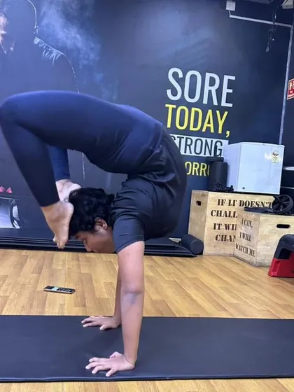 The scorpion handstand is a testament to the balance between strength, flexibility, and control. This is what my training philosophy is all about, integrating different disciplines to build a body that is not just strong, but also mobile and resilient. The sign behind me says it all: "Sore Today, Strong Tomorrow."