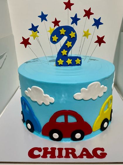 Simple, bright, and fun, this car-themed cake was made for a 2nd birthday. The colourful cars and star toppers are handcrafted to create a cheerful design that little ones absolutely love.