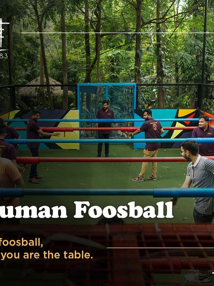 Another view of Human Foosball, where you are the table. The colorful court is set amidst lush greenery.