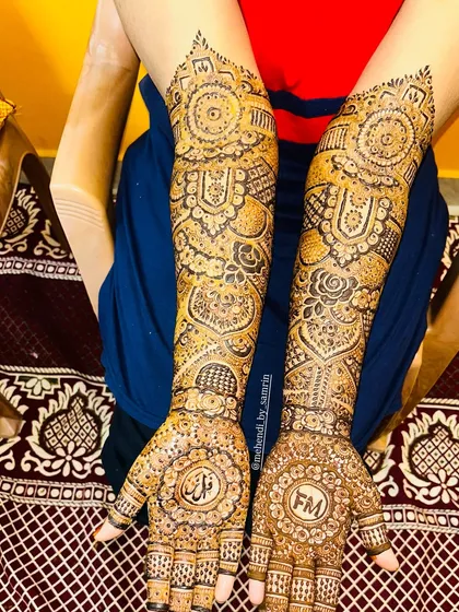 A full view of this beautiful bridal design, which includes personalized initials "FM" and a name in Arabic script.