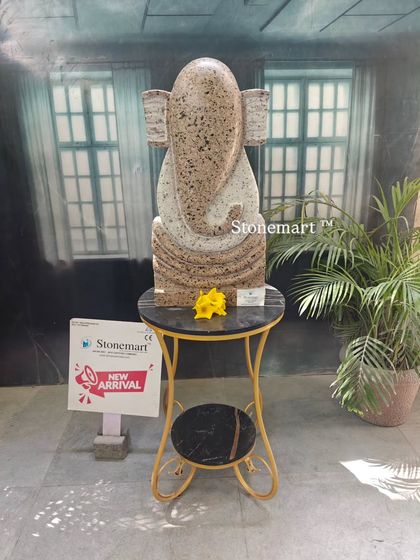 A full view of the 21-inch modern abstract Ganesha sculpture in speckled granite. This piece is hand-carved and designed to be a focal point in a contemporary home or garden setting.