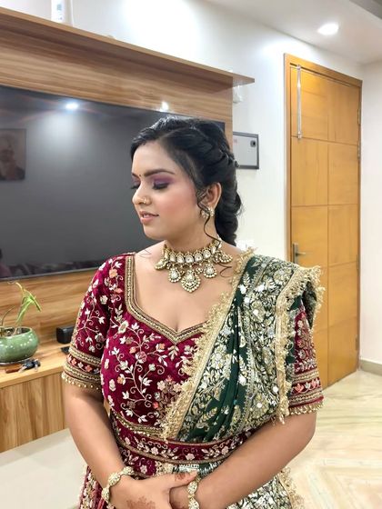 This side profile highlights the braided hairstyle and the flawless blend of the eyeshadow. The contouring defines her features while maintaining a soft, bridal glow.