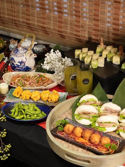 Another angle of a catered event, showing the breadth of our menu. We can include dishes like pork bao buns, croquettes, and noodle salads to complement traditional Japanese fare, creating a diverse and exciting menu for your guests.