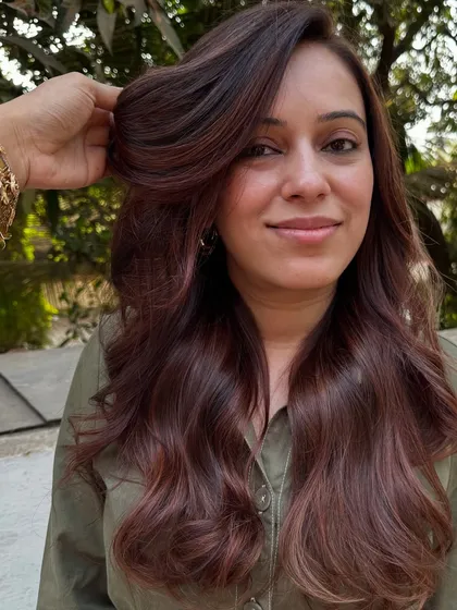 A 'Rose Gold' dream come true. We transformed her faded highlights into this stunning metallic pink shade. It’s a trendy yet sophisticated way to play with color.