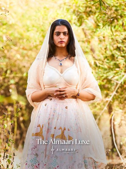 A softer, more romantic styling of the printed lehenga. The sheer dupatta draped over the head adds a touch of traditional grace, perfect for a wedding ceremony.