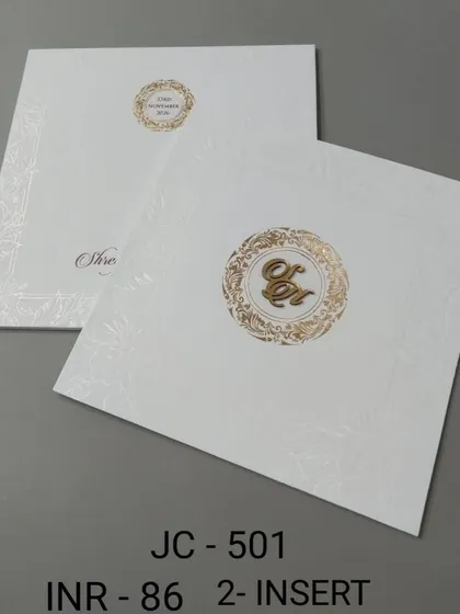 This classic white invitation features a simple gold monogram with a subtle embossed pattern in the background. It's a timeless and elegant choice for a formal wedding.
