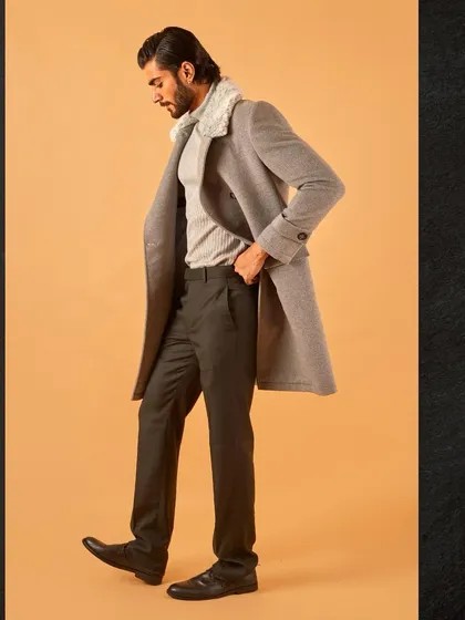 A full-length profile view of the grey overcoat, demonstrating its elegant length and tailored fit.