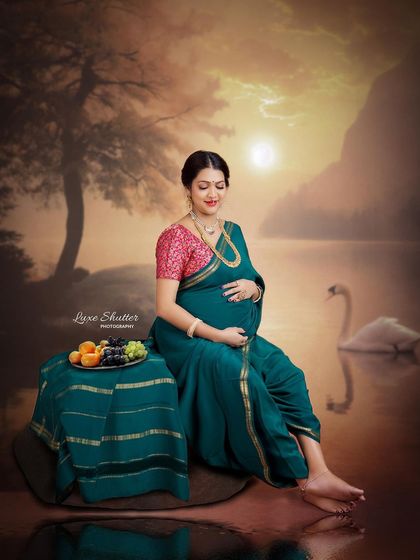 A moment of quiet connection with her unborn baby. The warm, golden light of the sunset backdrop enhances the peaceful and loving mood of this traditional portrait.