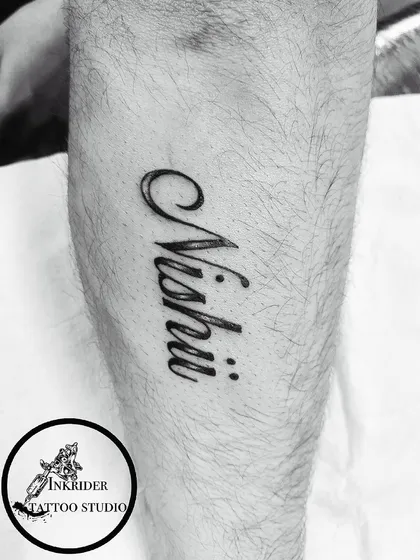 A clean, bold name tattoo on the leg. We ensure perfect clarity and style, no matter the placement.