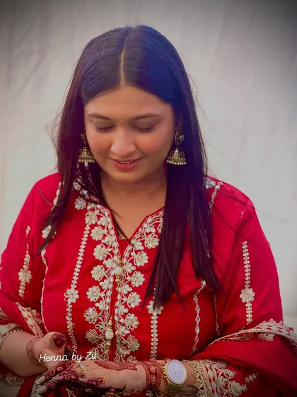 A candid moment of me looking down at my own Shreenathji mehendi. The joy of wearing a design that holds personal and spiritual meaning is truly unmatched.