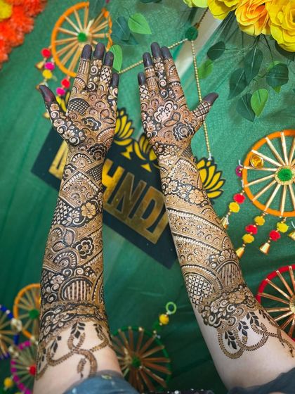 My bride Sonu looking so happy with her unique Indo-Arabic mehendi featuring snake motifs.