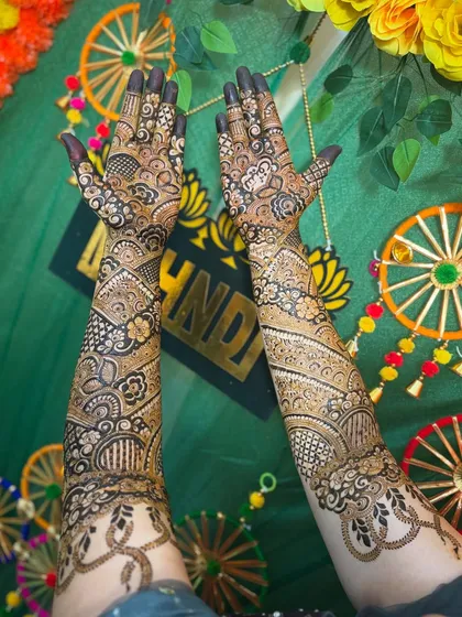 My bride Sonu looking so happy with her unique Indo-Arabic mehendi featuring snake motifs.