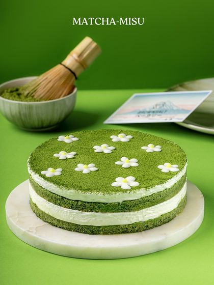 A full view of our Matchamisu cake from The Japan Edit, complete with a traditional matcha whisk to signify its authentic inspiration.