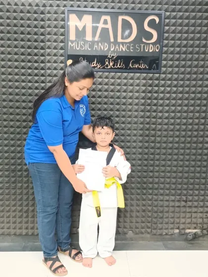 A proud moment for one of our youngest students as he receives his yellow belt certificate from Priyanshi Ma'am. This marks his first major achievement in his taekwondo journey.