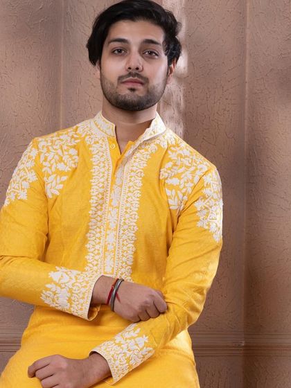 A close-up of the shoulder and chest embroidery on the zesty yellow kurta.