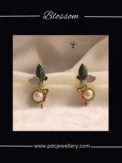 Blossom with these unique earrings inspired by nature. The design features a green enamel leaf, a pearl, and a touch of diamond sparkle, all in 18kt gold.