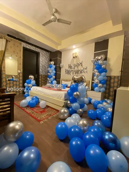 A different angle of the blue and silver birthday room, showing the extent of the balloon decorations.