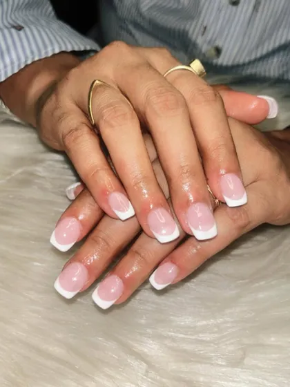 A classic French manicure on square-shaped nail extensions. This look is bold, clean, and always in fashion, perfect for a professional or glamorous style.