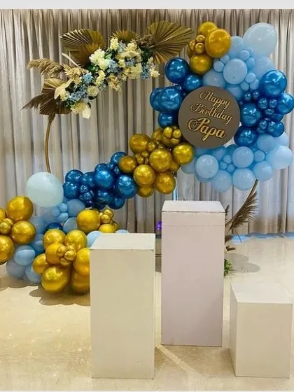 An elegant 'Happy Birthday Papa' decoration. This sophisticated balloon arrangement in blue and gold is accented with dried floral elements for a modern, masculine feel.