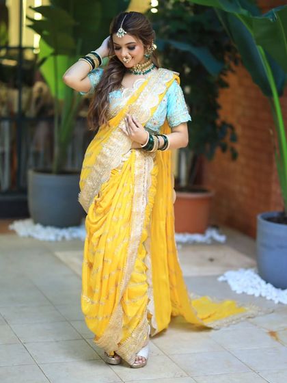 Another shot of the beautiful yellow Nauvari saree. The hairstyle is simple and elegant, allowing the intricate outfit to be the star.