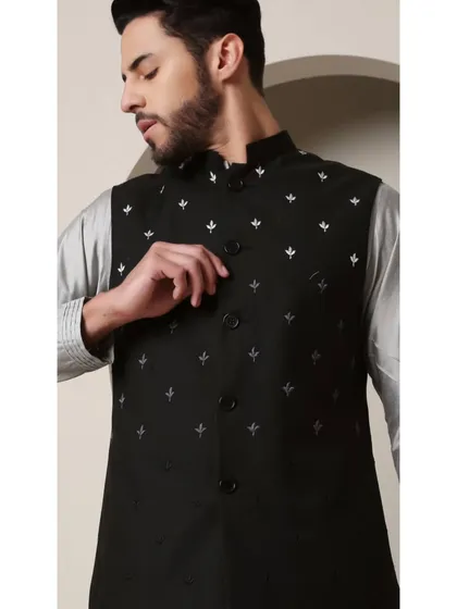 A close-up of the Shoorveer bandi set. A black embroidered vest is layered over a grey silk kurta, creating a sophisticated contrast.
