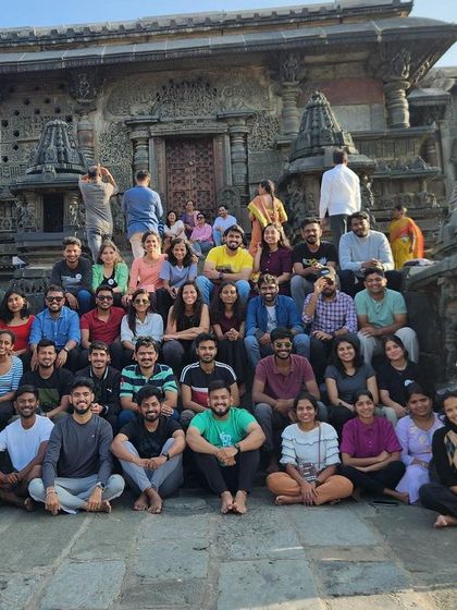 Our group posing for a photo at the beautiful Belur Temple, a historical site we visit during our Netravati trek weekend.