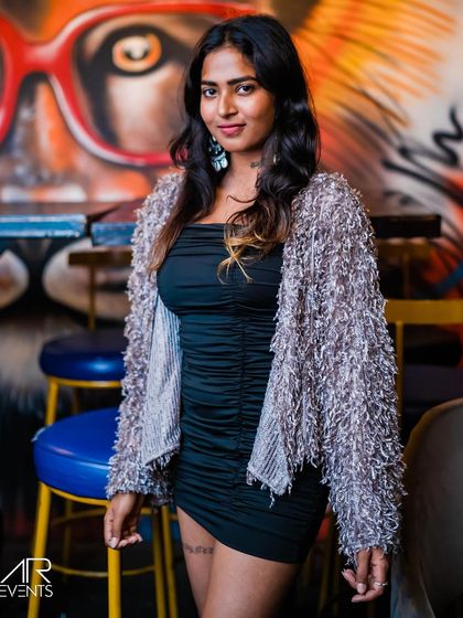 A guest posing against the graffiti wall.