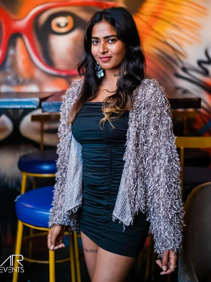 A guest posing against the graffiti wall.