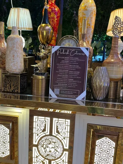 Attention to detail is key. This close-up shows my custom-designed buffet counter, complete with elegant decor and a clearly displayed menu, ensuring your event looks as good as the food tastes.
