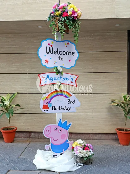 A custom welcome sign for Agastya's 3rd birthday, featuring George Pig and a colorful rainbow, setting the theme from the very beginning.
