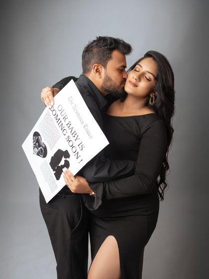 A fun and creative pregnancy announcement. The couple uses a custom newspaper prop to share their exciting news in a stylish and memorable way.