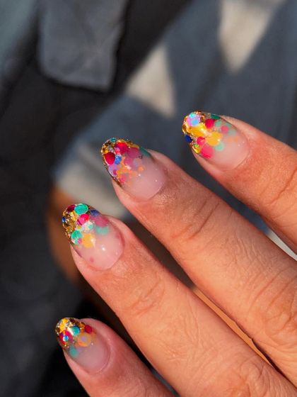 A party on your nails. This design features colorful, chunky glitter suspended in a clear gel for a fun, confetti-like effect.