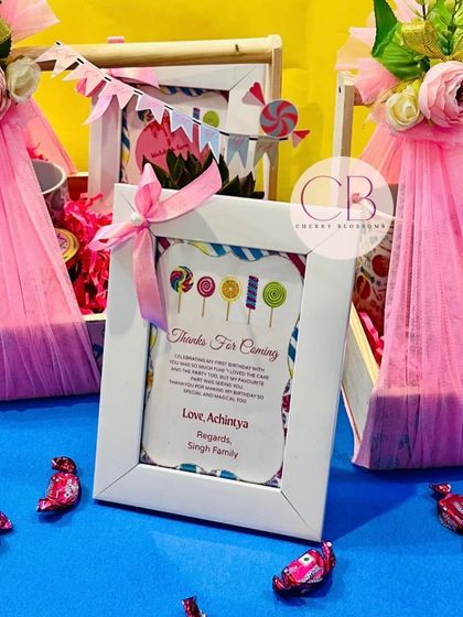 A personalised thank you note in a white frame, part of our candy-themed first birthday return favours. It's these little details that make a gift truly special and memorable for your guests.