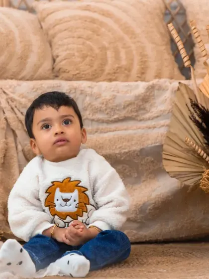 A close-up of a sweet baby boy in our warm and earthy boho setting.