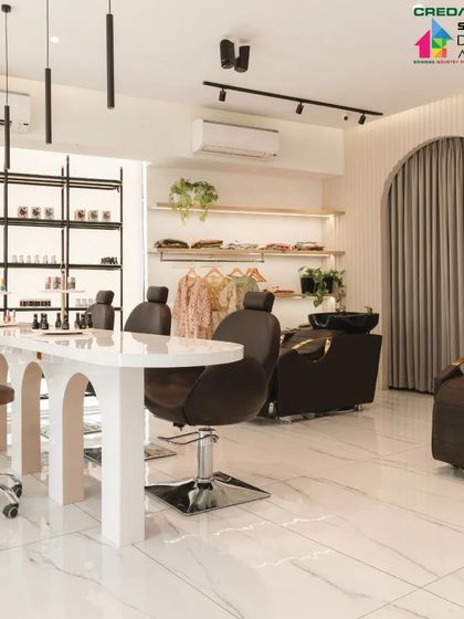 A wide view of the salon interior, showing the nail bar, hair washing stations, and the curtained archway leading to private rooms.