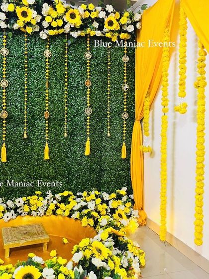 Another side view of the grand Haldi setup, highlighting the layers of drapes and flowers.