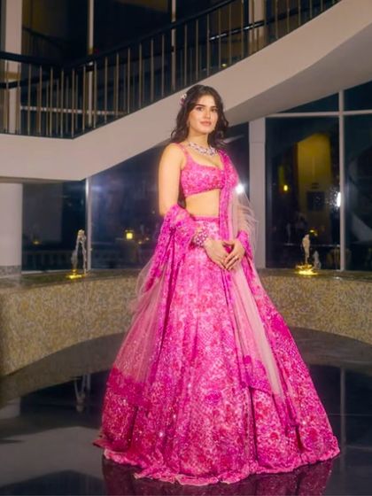 A vibrant pink lehenga that radiates joy and celebration. This is a fantastic option for a sangeet or even the main wedding ceremony for a bride who loves color.