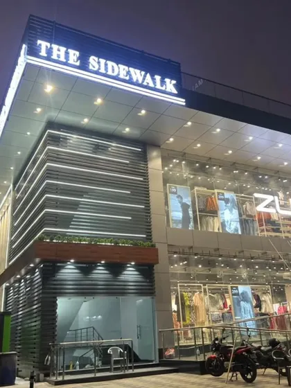 A street-level view of the commercial building's entrance, designed to be modern and inviting.