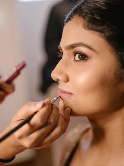 A behind-the-scenes moment of the lip color application. I always use a brush for precise, long-lasting results, ensuring the look stays perfect all day.