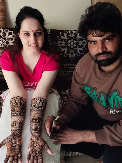 A photo with a client after finishing her beautiful full-arm mehandi. I ensure every client leaves with a smile.