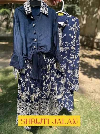 A sophisticated twinning set for siblings. This navy blue floral print is available in a girls' skirt and tie-front top, and a matching boys' kurta.
