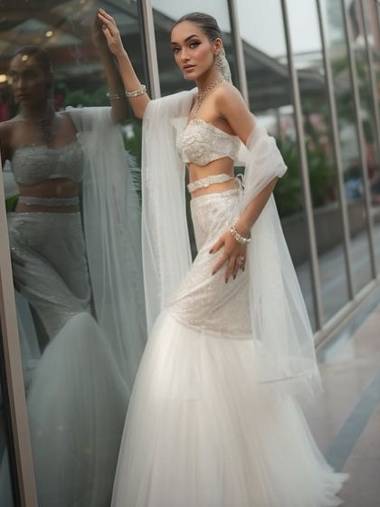 Slaying this glam look in a modern white mermaid-style lehenga. The makeup is sharp and sophisticated.