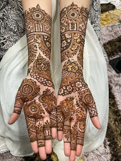 A classic and elegant full bridal design. The patterns are symmetrical, with matching mandalas on the palms and identical bands running up the forearms for a timeless look.