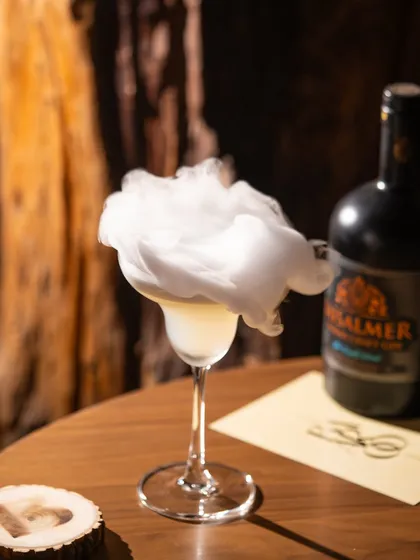 Creating drama with a smoky gin cocktail. This kind of shot is perfect for a bar's social media, creating intrigue and highlighting the craft behind the drink.