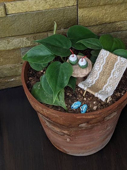 Have a relaxing weekend. This miniature beach scene, complete with a deck chair and tiny tender coconuts, is perfect for adding a vacation vibe to your favorite houseplant.