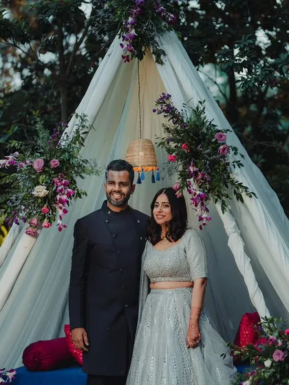 For intimate celebrations, we focus on creating cozy and stylish spaces. This elegant teepee, adorned with delicate florals, served as a perfect, personal backdrop for the couple's portraits.
